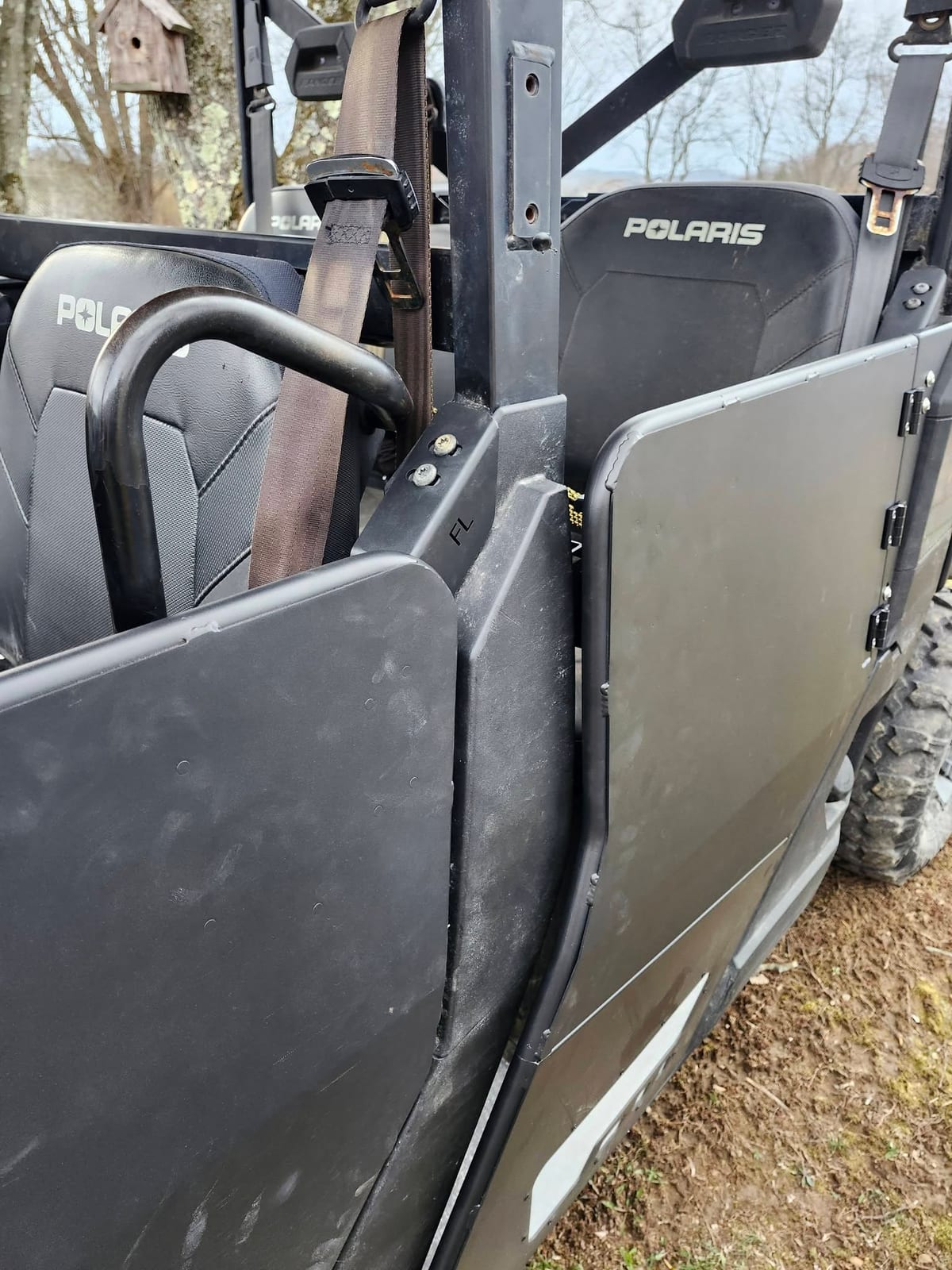 A Polaris side-by-side with its doors open after a door repair