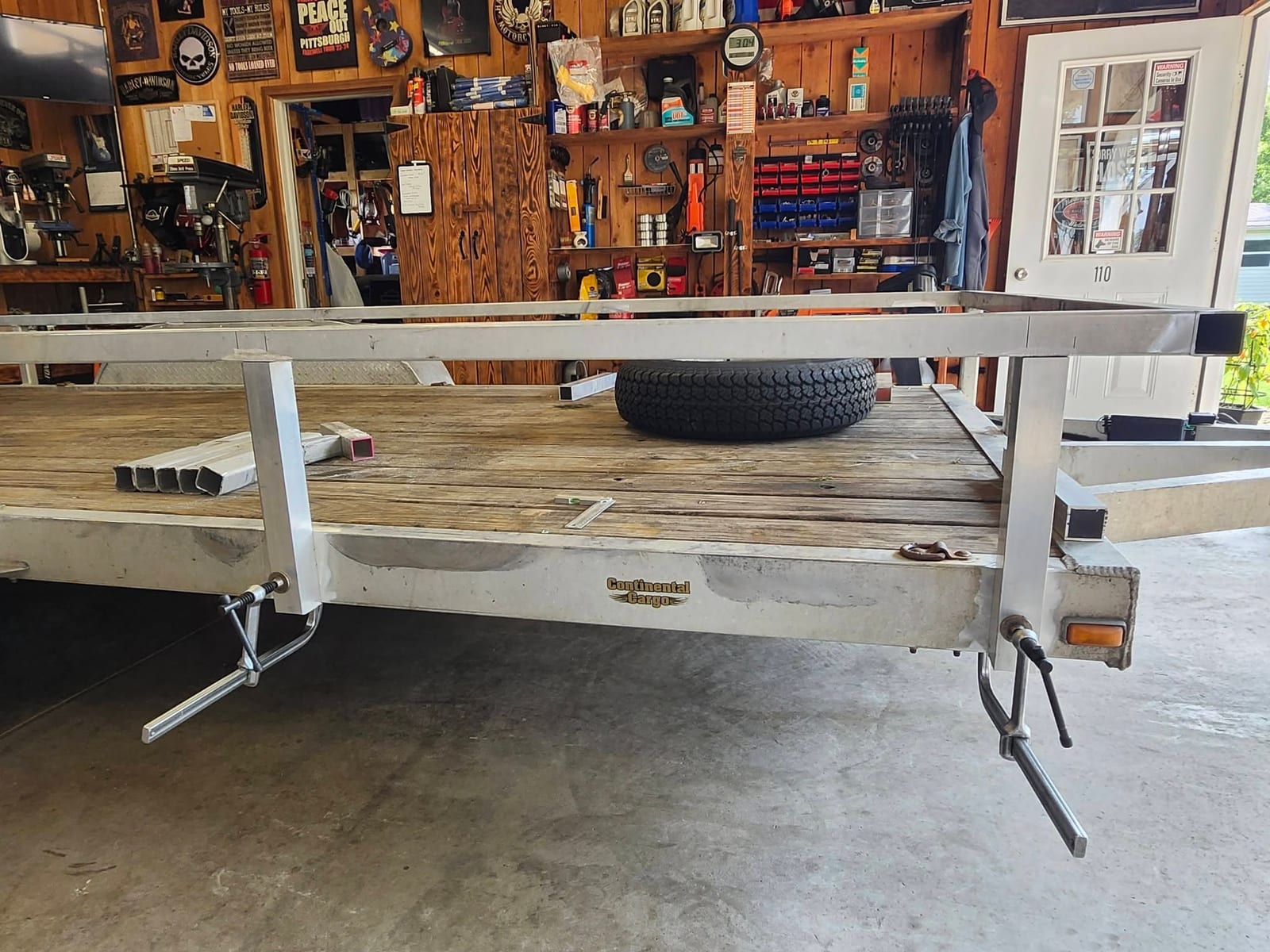 A new aluminum side rail frame fitted to a utility trailer inside the Robinson Welding shop