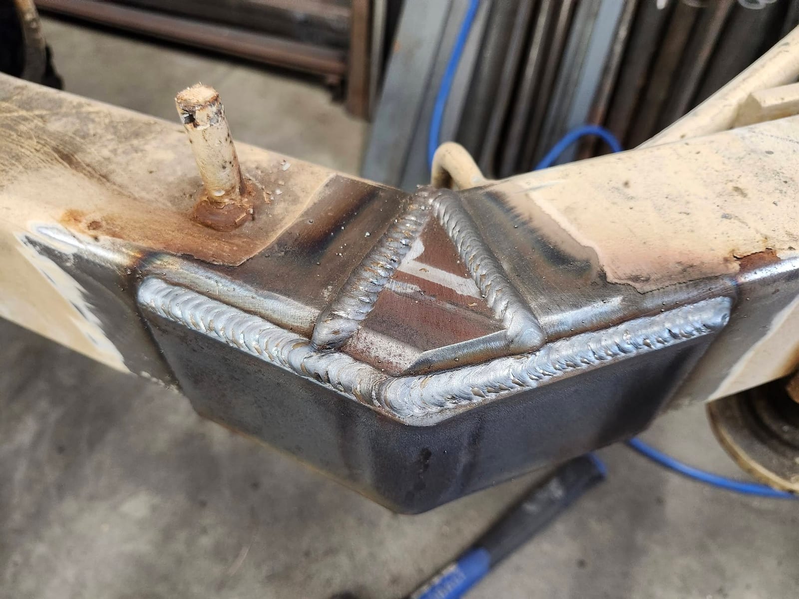 Close-up of evenly stacked weld beads on a newly plated trailer tongue repair