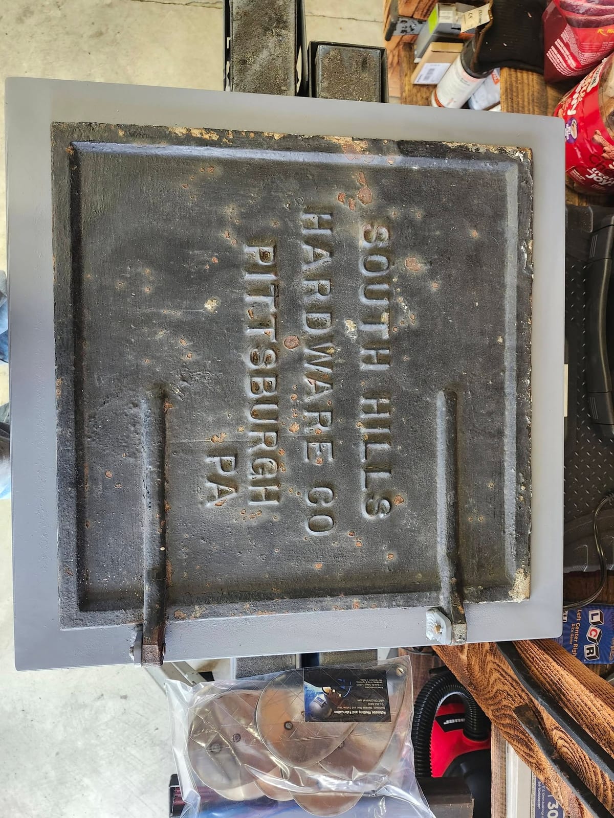 An antique South Hills Hardware Co cast iron plate from Pittsburgh mounted in a custom fabricated steel frame