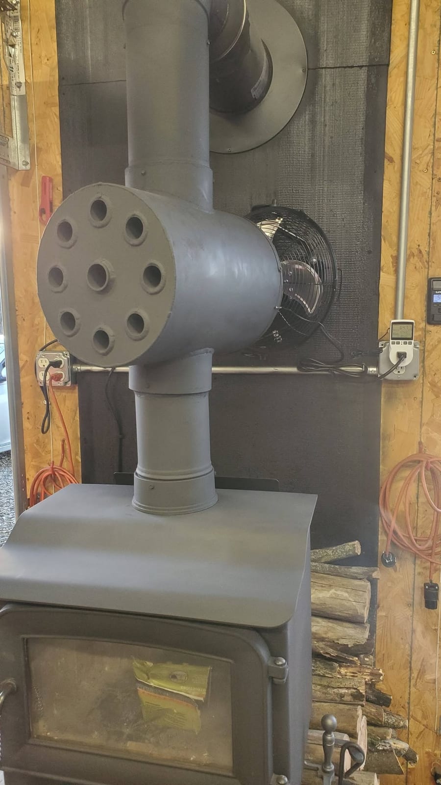 A shop fabricated multi-tube heat exchanger welded into the flue of a wood stove