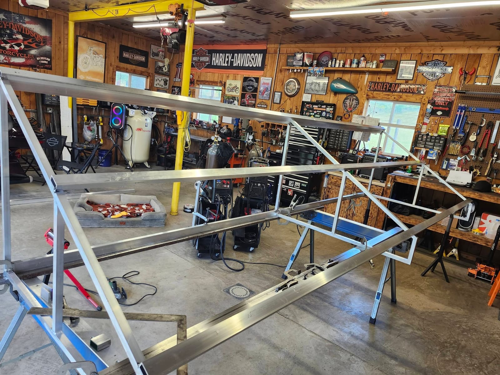 Inside the Robinson Welding and Fabrication shop near Freeport, Pennsylvania, with an aluminum frame under the one ton gantry crane beside the MIG and TIG welders